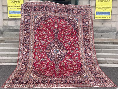 Lot 643 - A Persian Kashan carpet, the madder ground...