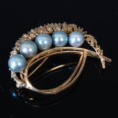 Lot 235 - A yellow metal and five stone pearl set brooch,...