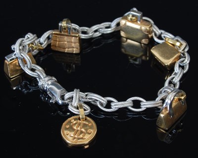 Lot 235I - A yellow and white metal charm bracelet by...