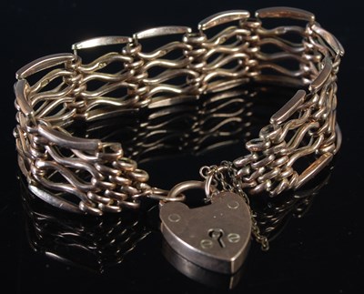Lot 247 - A yellow metal gatelink bracelet with heart...