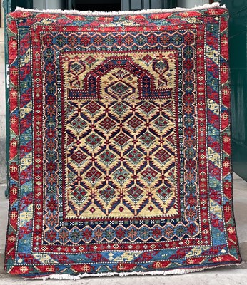 Lot 632A - A prayer rug, 20th century, the ochre ground...