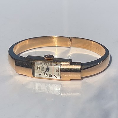 Lot 50F - A ladies 18ct gold Venus bangle watch, the...