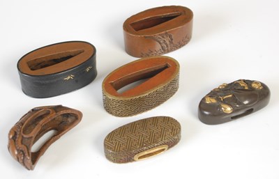 Lot 193 - A group of Japanese bronze sword fittings...