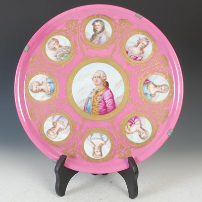 Lot 424 - A Sevres porcelain pink ground circular plaque...