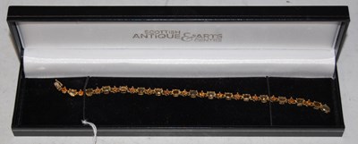 Lot 176B - A 9ct gold citrine and topaz set bracelet