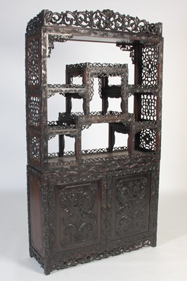 Lot 794 - A Chinese darkwood display cabinet, late 19th...