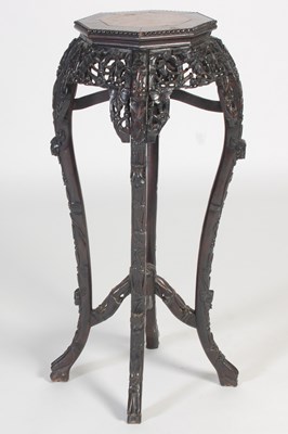 Lot 773 - A Chinese darkwood urn stand, late 19th...