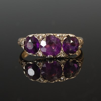 Lot 102 - A Victorian amethyst three stone ring, with...
