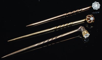 Lot 226 - A gold and diamond cluster tie pin; and two...