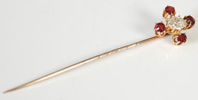 Lot 231 - A gold, garnet and diamond tie pin, formed as...