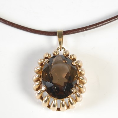 Lot 43 - A 9ct gold mounted smokey quartz pendant...