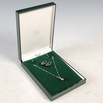 Lot 52 - A 9ct white gold pearl and diamond chip...