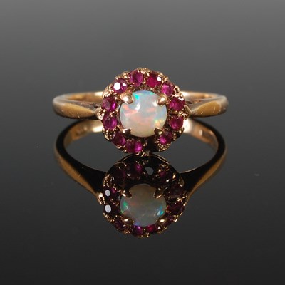 Lot 65 - A 9ct gold opal and garnet cluster ring (one...