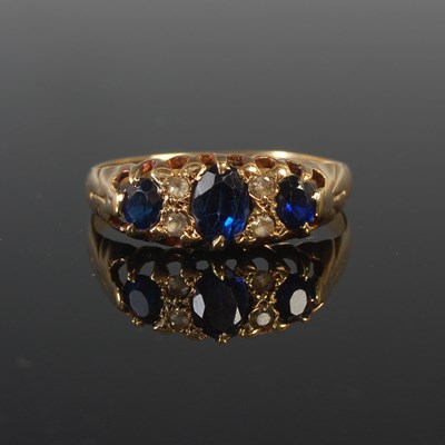 Lot 68 - An 18ct gold sapphire and diamond seven stone...