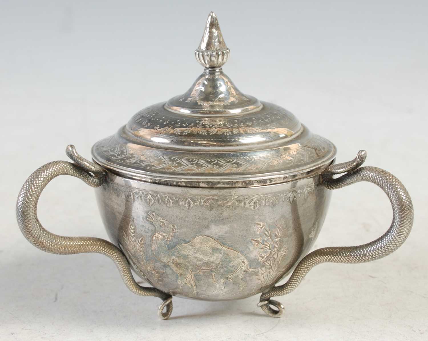 Lot 140 - An Indian silver three-handled cup and cover,...