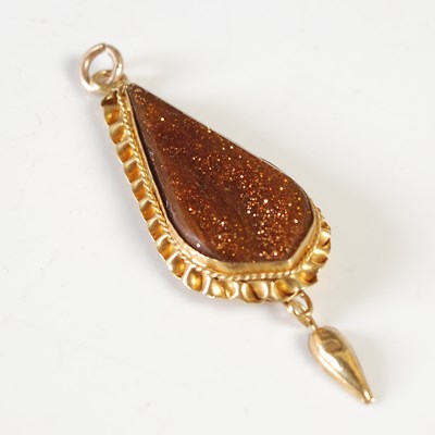Lot 242 - A yellow metal mounted aventurine pendant, the...