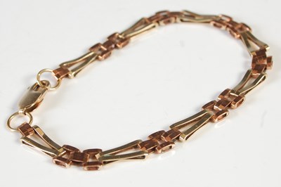 Lot 201 - A yellow metal two colour bracelet, stamped...