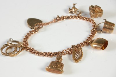 Lot 243 - A 9ct gold charm bracelet suspending seven...