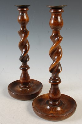 Lot 432 - A pair of oak barley twist candlesticks, 31cm...