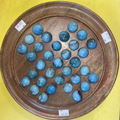 Lot 442 - A solitaire board set with mottled blue glass...