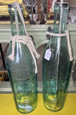 Lot 451 - A pair of large blue glass ocean bottle...