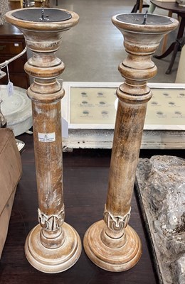 Lot 464 - A pair of limed wood candle stands with...