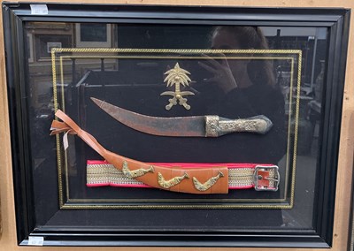 Lot 618 - A Middle Eastern dagger in a framed and glazed...