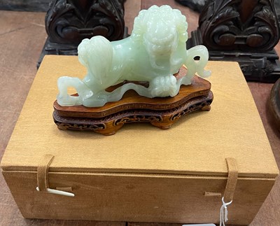 Lot 498 - A Chinese carved green stone figure of a...