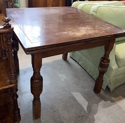 Lot 656 - A vintage oak extending dining table on turned...