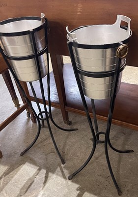 Lot 663 - A pair of ice buckets on black painted metal...