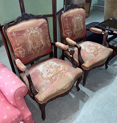 Lot 670 - A pair of French walnut upholstered fauteuil...