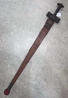 Lot 551 - An African Takouba sword with leather scabbard,...
