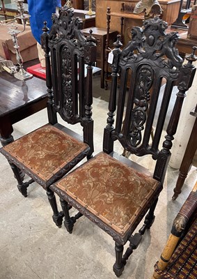 Lot 683 - A pair of Jacobean style oak hall chairs, the...