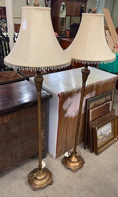 Lot 704 - A pair of lacquered brass standard lamps and...