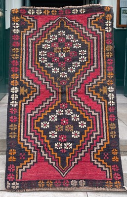 Lot 800 - A Baluchi rug, the madder ground decorated...