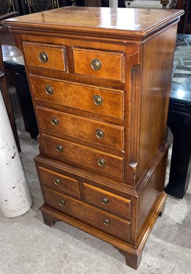 Lot 725 - A reproduction walnut miniature chest on chest,...