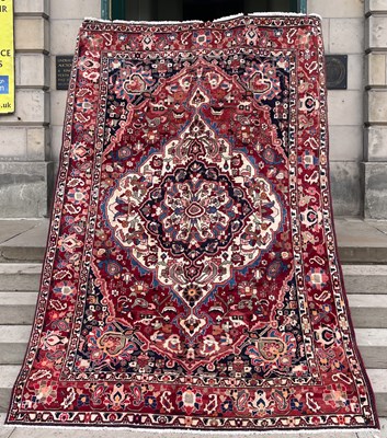 Lot 811 - A Persian Bakhtiari carpet, the madder ground...