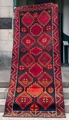 Lot 818 - A Persian Lori long rug, the rectangular...