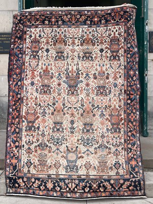 Lot 820 - A Persian rug, the rectangular ivory ground...
