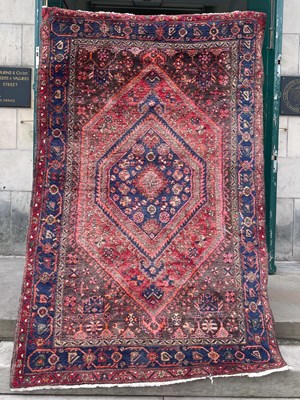 Lot 821 - A Persian rug, the rectangular field centred...