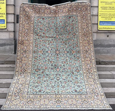 Lot 822 - A Persian Kashan carpet, the rectangular pale...