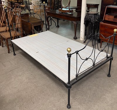 Lot 750 - A black painted metal single bed, with brass...