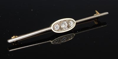 Lot 299C - A white and yellow metal three stone diamond...