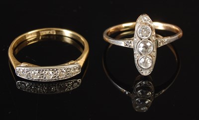 Lot 305A - A white and yellow metal three stone diamond...