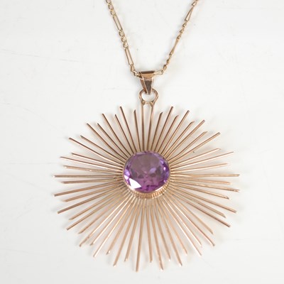 Lot 305C - A yellow metal and amethyst set sunburst...