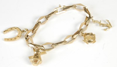 Lot 305D - A 14ct gold charm bracelet suspending four...