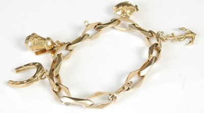 Lot 305 - A 14ct gold charm bracelet suspending four...