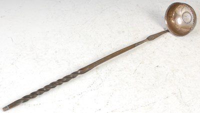 Lot 309 - An antique silver toddy ladle with coin set...