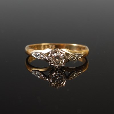 Lot 23 - An 18ct yellow and white gold solitaire...