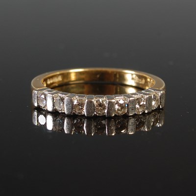 Lot 31 - An 18ct white and yellow gold seven stone...